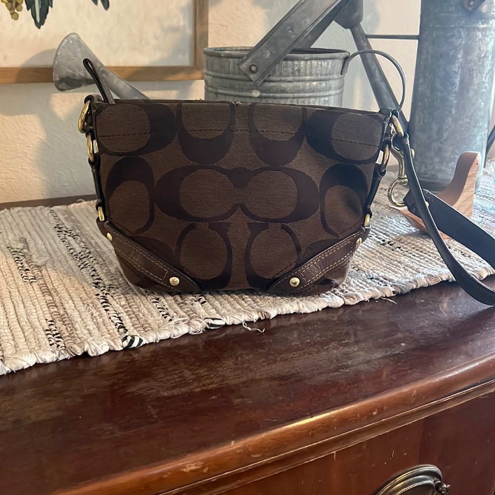 Brown with gold Carly COACH small purse.  Wear over shoulder or wristlet style.